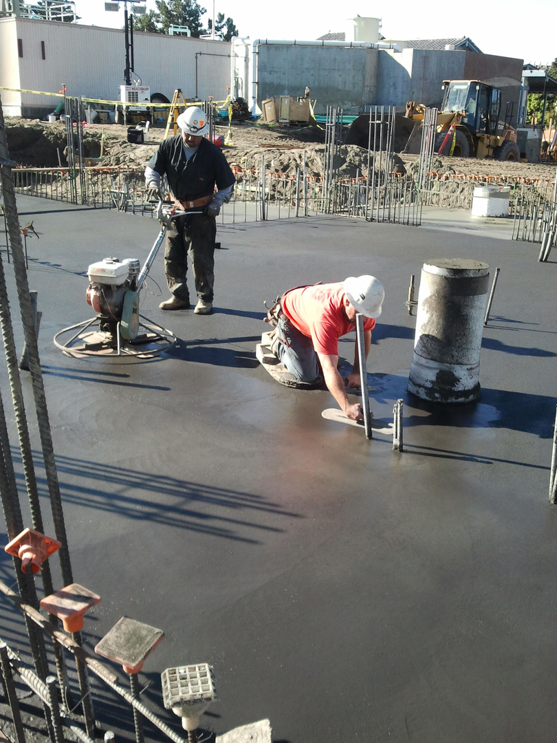 Two Workers Working on a Wet Concrete Flooring