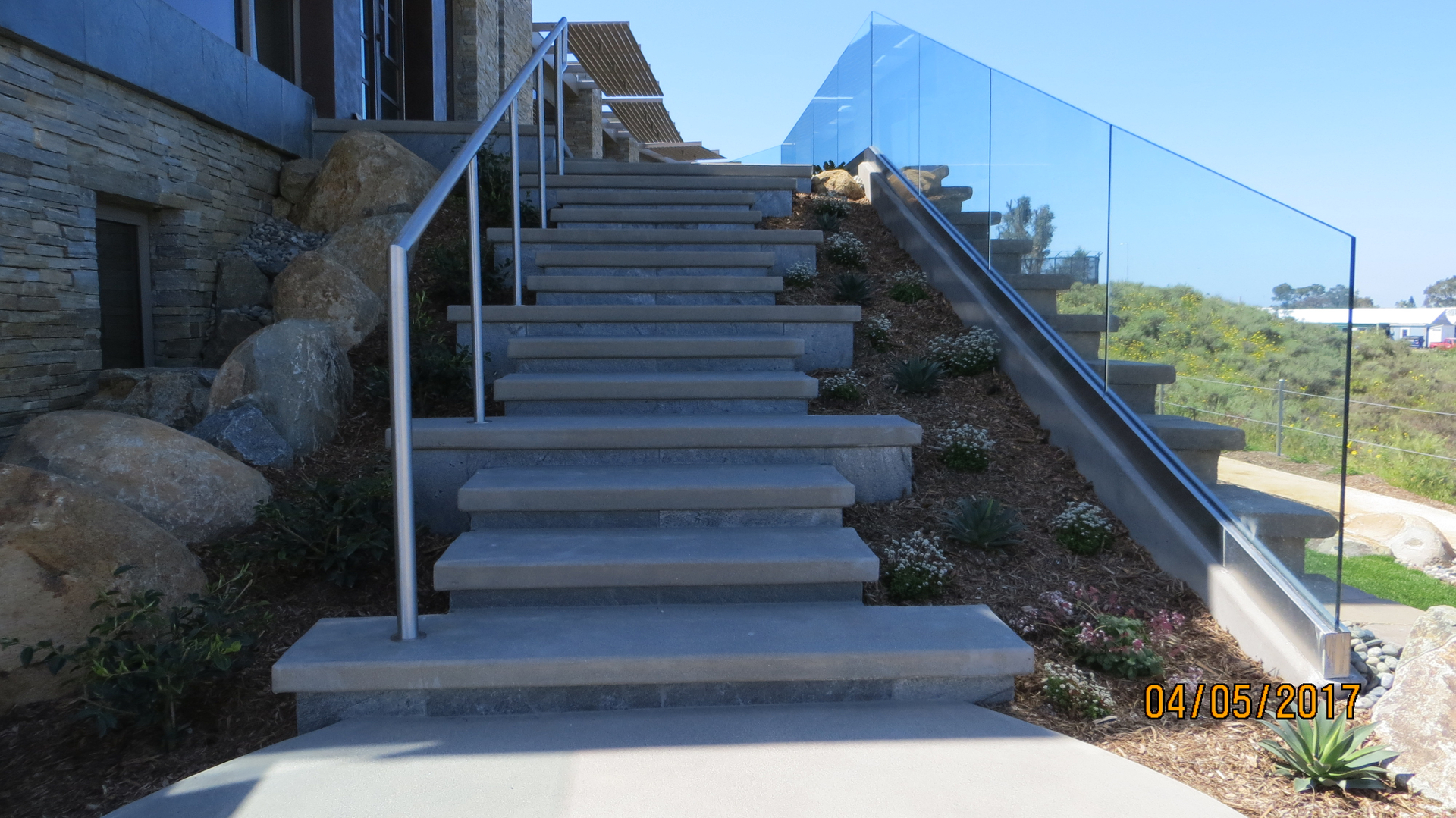 A Concrete Slab Stairs With Glass Railing