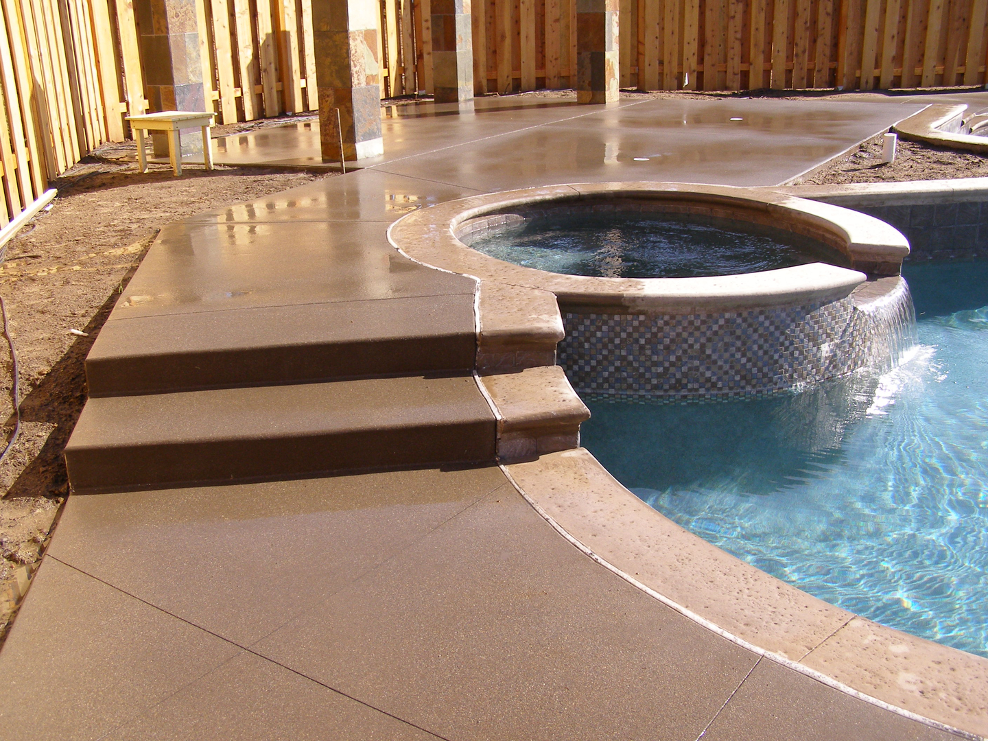 A Brown Color Tiled Floor by a Pool
