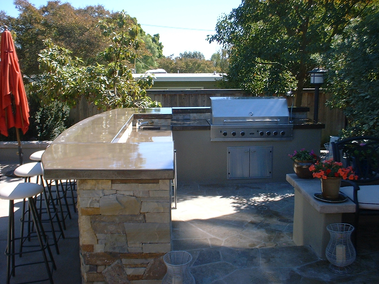 An Outdoor Kitchen Area With a Grill Install