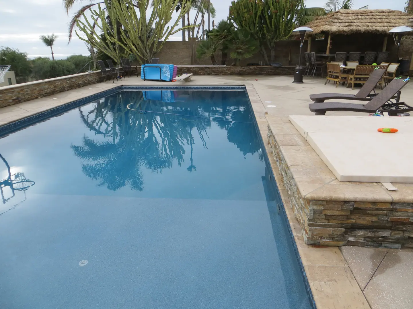 A Blue Pool Area With Limestone Surfacing