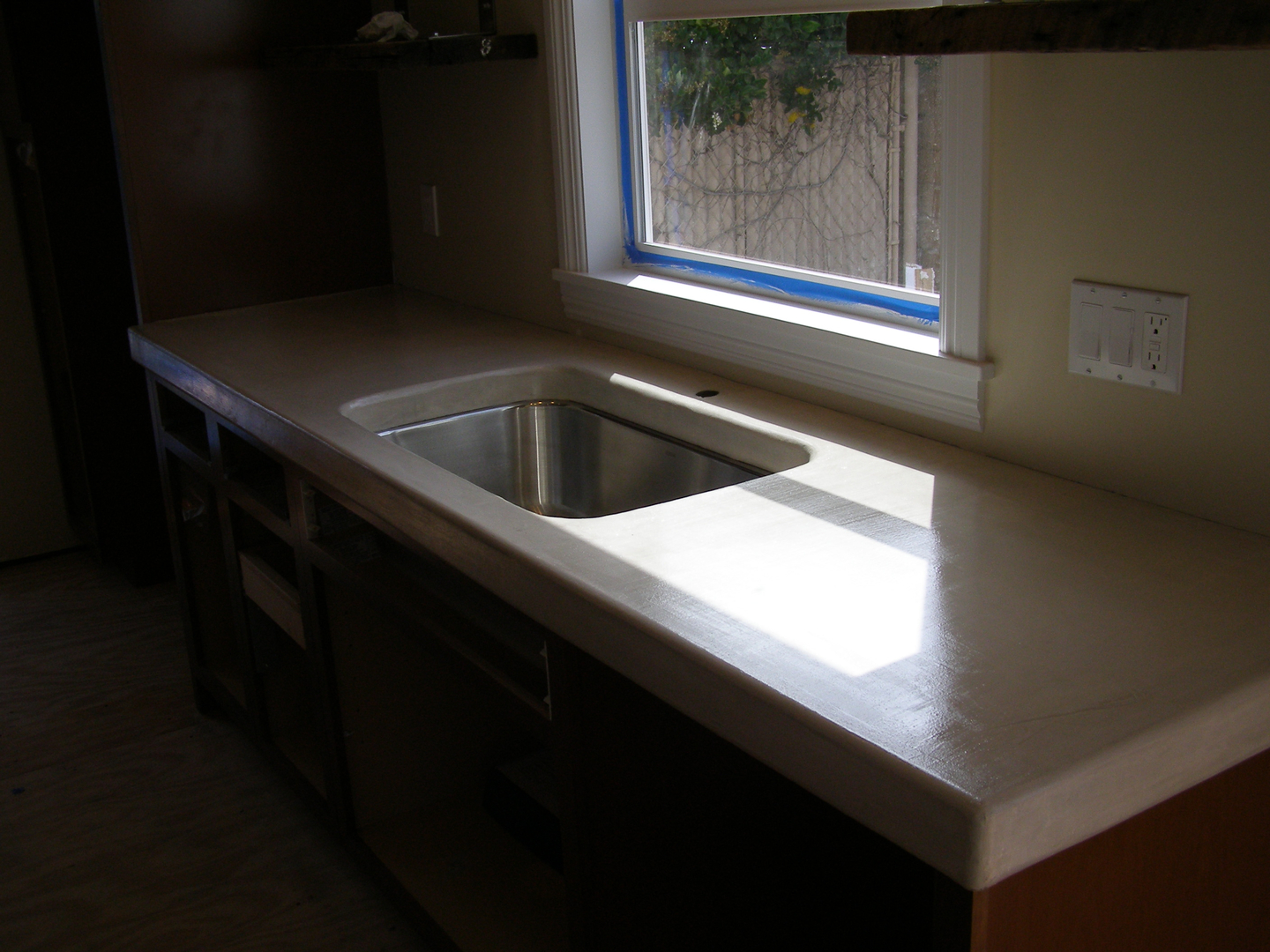 A Stainless Steel Sink Infront of a Glass Window