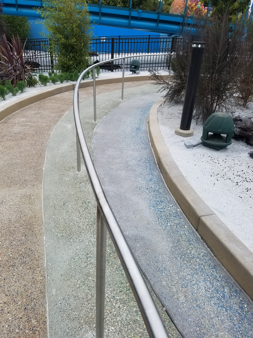A Cement Pathway for Water With a Steel Railing