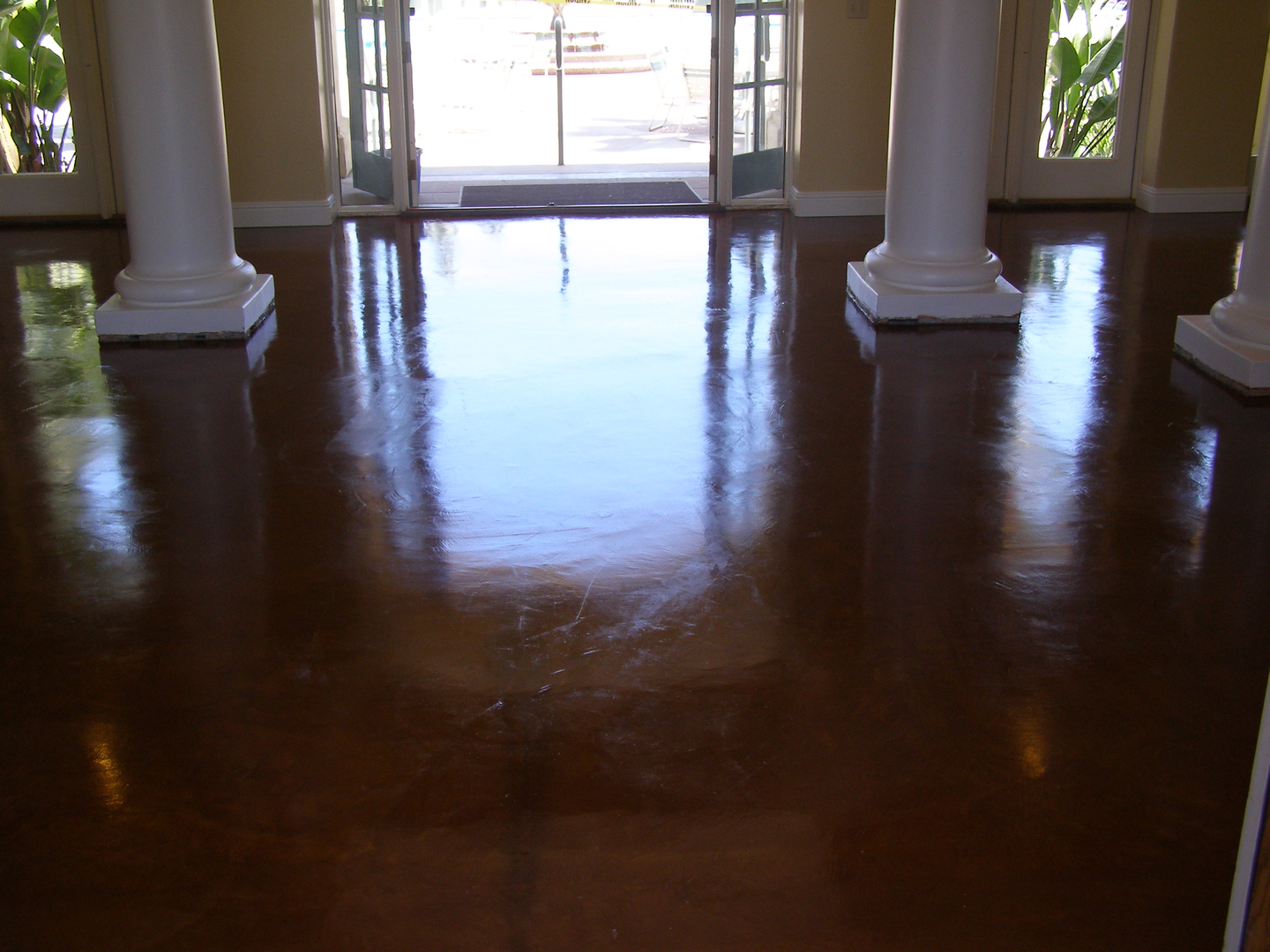 A Brown Color Glazing Floor With White Pillars