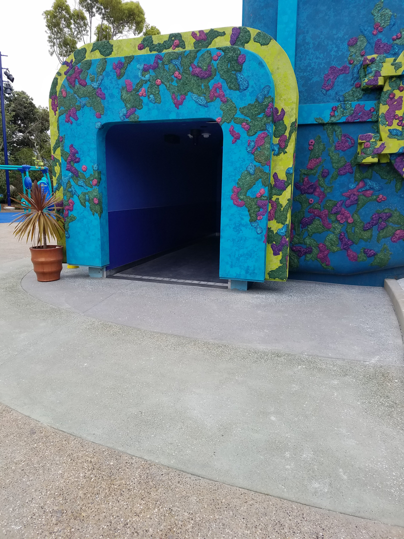 A Blue and Yellow Entrance With Purple Flower Design