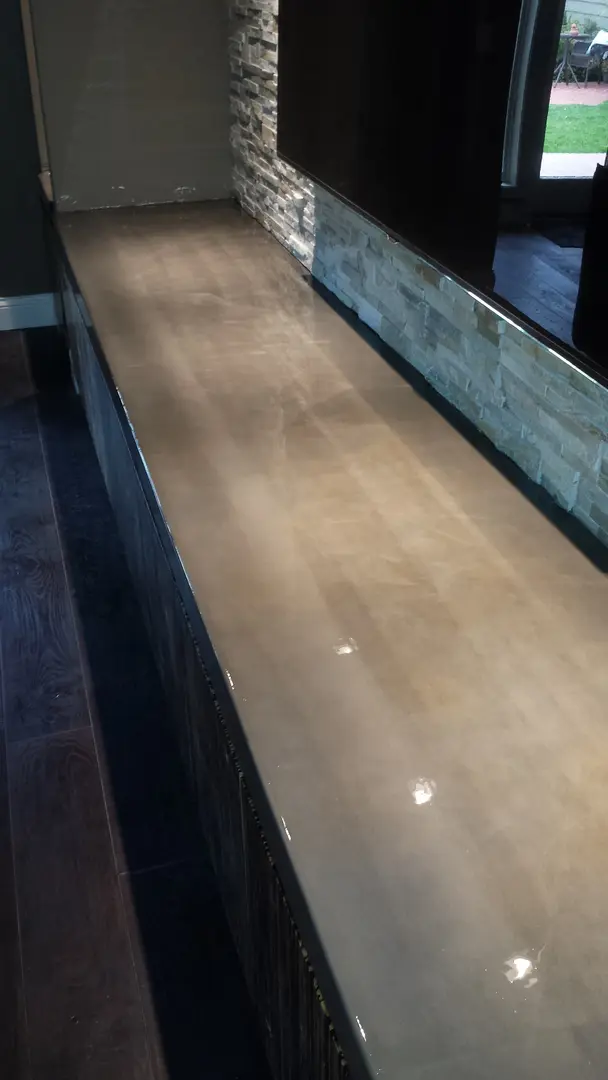 A Glazing Cream Countertop With a Stone Wall