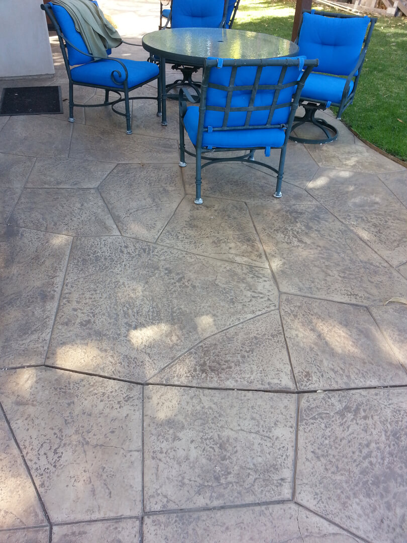 A Stone Floor Surface With Blue Chairs