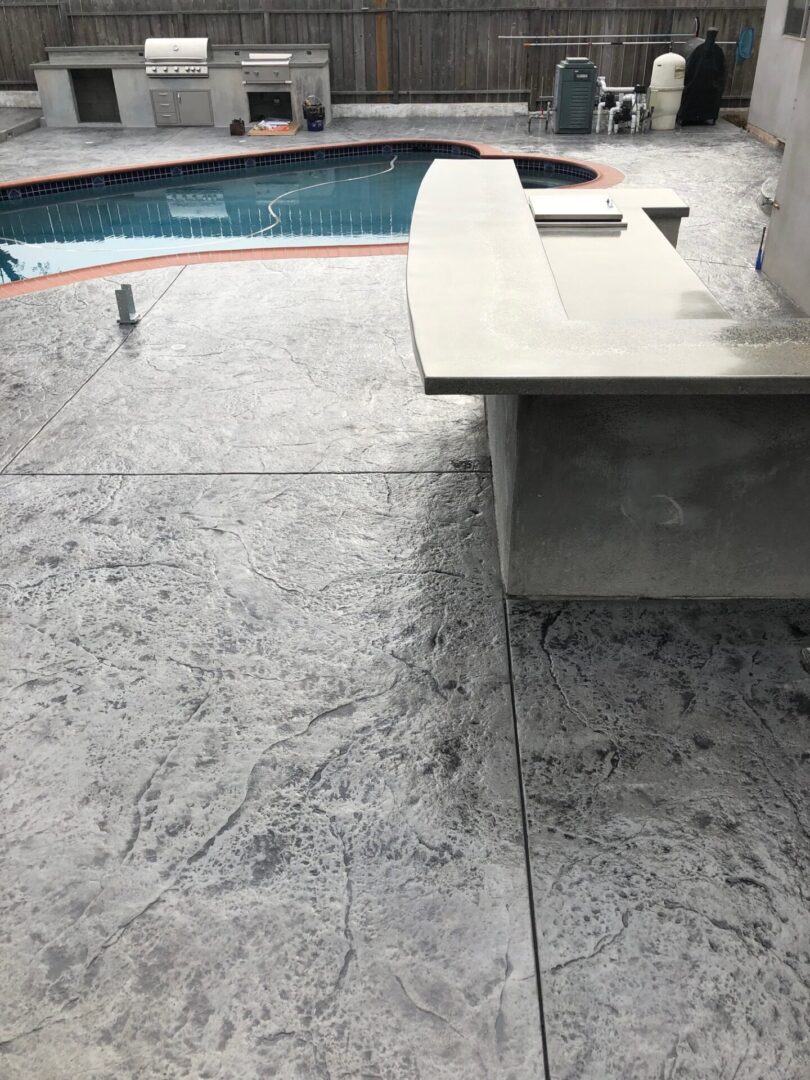 Closeup view of stamp concrete floor around the pool